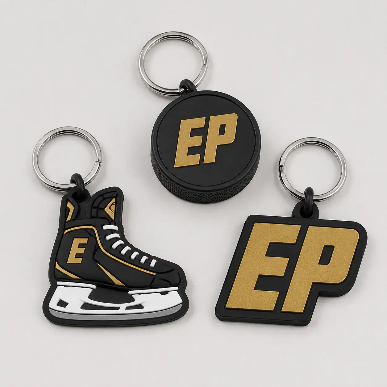 Three EDGE hockey keychains in puck skate and EP monogram designs